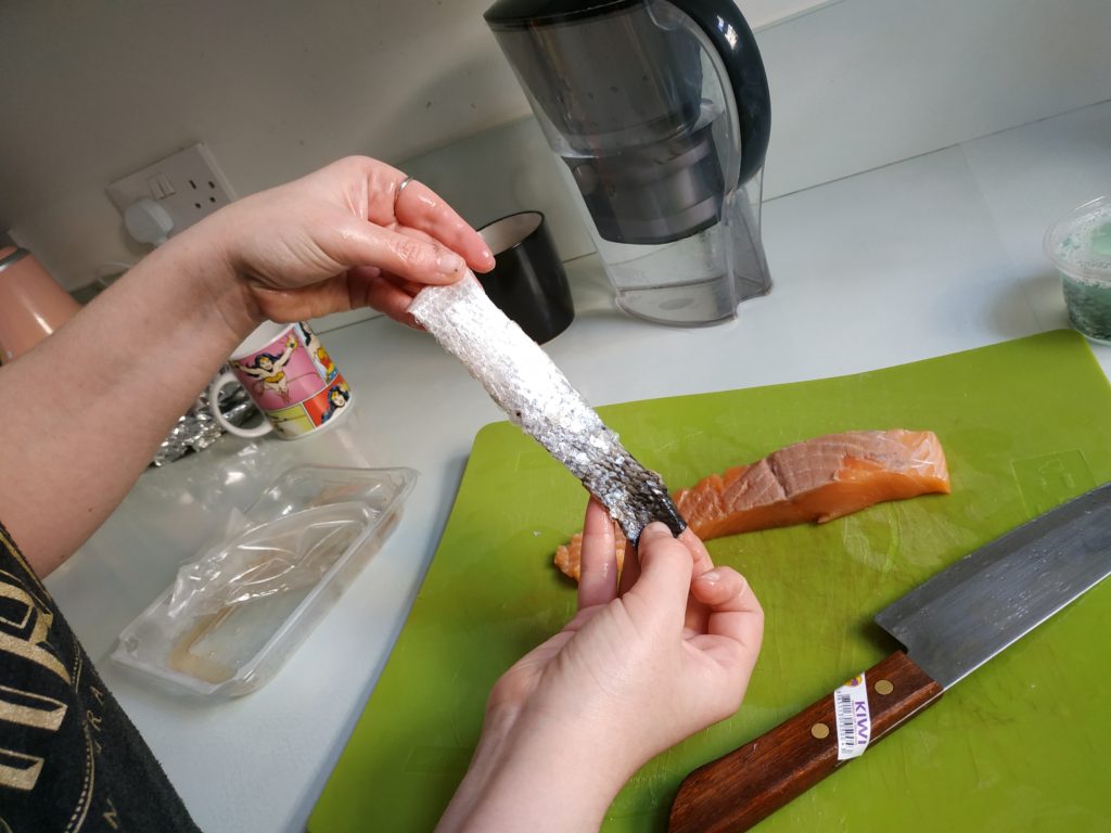 Making fish leather, skinning a salmon fillet